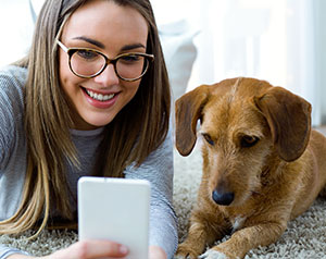 Woman and Dog Looking at Phone