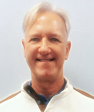 man in white smiling